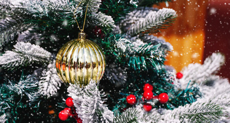Christmas tree  decoration with gold ball and snow for background. Merry Christmas and Happy Holidays greeting card, frame, banner. New Year. Winter holiday theme.