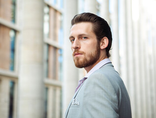 Fototapeta premium handsome businessman, summer day, outdoors near modern business centre