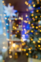 Fototapeta na wymiar Blurred Christmas tree in the room