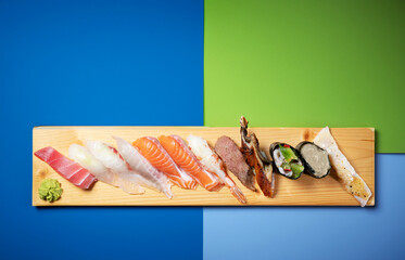 Different types of sushi on a wooden plate
