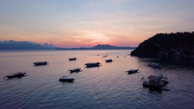 Scenic Aerial Panorama Drone Video of the Coast and Bay of Sabang in Puerto Galera, Mindoro, Philippines during Sunrise