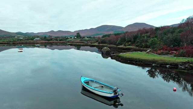 Sneem Ring Of Kerry wild Atlantic way boat on still waters with view of the autumn mountains