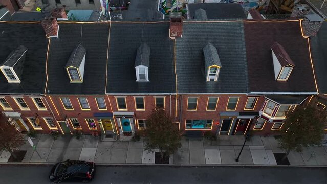 Row houses in American city decorated with LED Christmas lights. Aerial view.