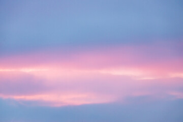 A beautiful sky tinted by the sun leaving vibrant shades of gold, pink, blue and multicolored. Clouds in the twilight evening and morning sky. Image of a cloudy sky in the evening and during the day