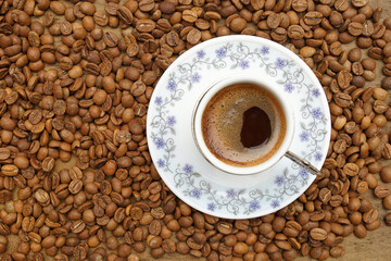 coffee beans on the ground and Turkish coffee on it, coffee in a cup