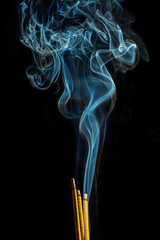 Smoke from incense in movement on a black background. It is abstract. - 695222344
