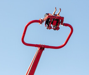 People on the rides take off against the blue sky