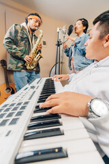 Pianist, saxophonist and singer in a music record studio