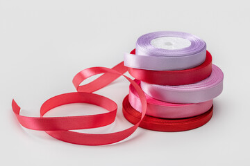 Several rolls of satin ribbon for wrapping gifts. Studio shot, isolated.
