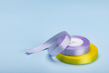 Two rolls of satin ribbon for gift wrapping. Studio shot.