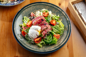 salad with poached egg and fried tuna