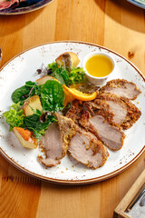 roast duck fillet with sauce and vegetables on a plate