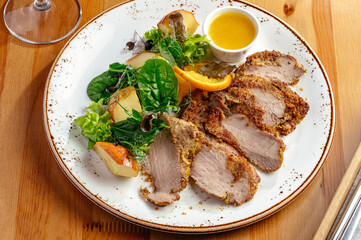 roast duck fillet with sauce and vegetables on a plate