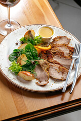 roast duck fillet with sauce and vegetables on a plate