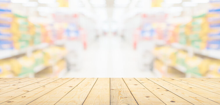 Empty wood table top with spet food shop blurred background