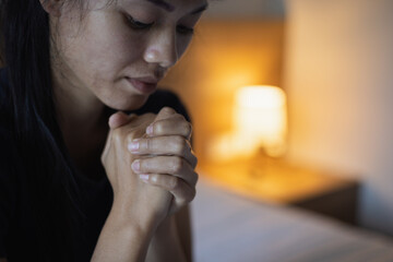 Christian woman praying in bedroom, woman hands praying to god, begging for forgiveness and believe...
