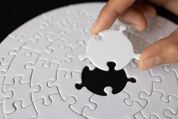  Hand put the last piece of jigsaw puzzle to complete the mission, Business solutions, success and...