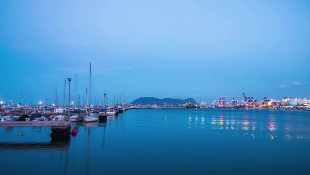  Luxury yachts and boats moored in the marina at Gibraltars Ocean Village. night to day time lapse