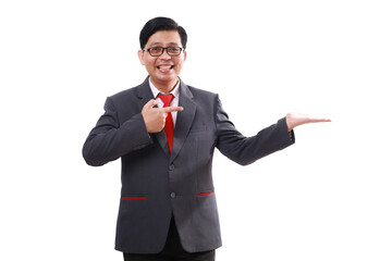 Happy asian businessman standing while pointing and presenting sideways. Isolated on white
