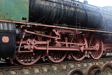 Fototapeta na wymiar Transmission system of an old train. Traction wheels of a steam train