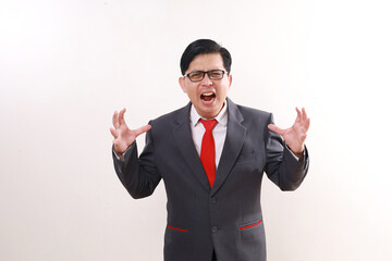 Angry asian businessman standing while screaming. Isolated on white background