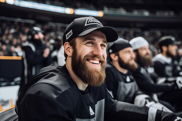 Smiling male fan on the tribune of a hockey stadium