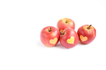 Fresh red apples with heart shape on it isolated on white background, healthy eating, health, holiday concept, copy space