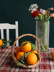 Oranges and flowers on the table