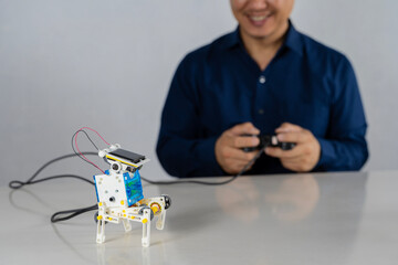 Teacher collects a handmade metal and plastic robot. STEM education for children and teenagers,...