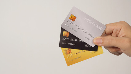 Hand is holding three credit cards isolated on white background..