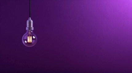 A lamp hangs on a purple wall and illuminates it, space for text or presentation