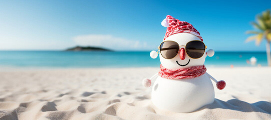Celebrating the New Year on the sunny sea coast. Snowman in sunglasses on the beach. Concept: Christmas on an exotic beach.