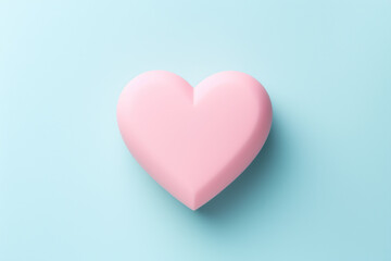 Single pink heart on a blue background. The concept illustrates simplicity and love.