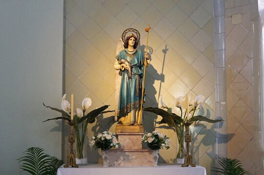 Holy statue shrine figure of St. Raphael, the Archangel holding staff and fish who stand before the throne of the Lord, one of the three mentioned by name in the Bible- Barcelona, Spain