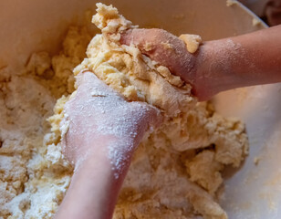 Hands are kneading cookie dough.