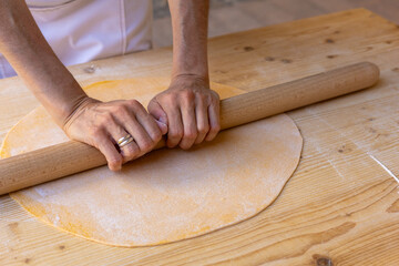 handmade tagliatelle with rolling pin, eggs, flour and water