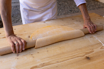 handmade tagliatelle with rolling pin, eggs, flour and water