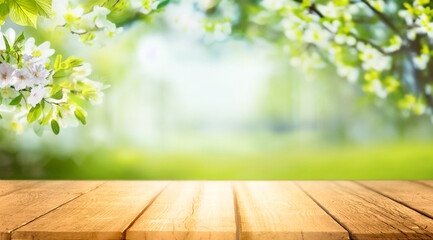 Spring beautiful background with green lush young foliage and flowering branches with an empty wooden table on nature outdoors in sunlight in garden. - 695296336
