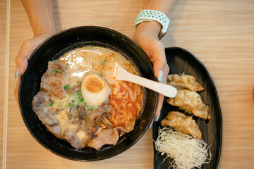 Miso Ramen Asian noodles with pork in bowl on wood background. Japanese cuisine. Top view