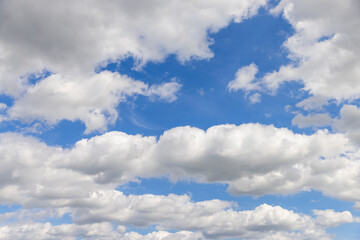 sunny weather with white clouds on a blue sky background