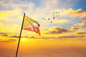 Waving flag of Bhutan against the background of a sunset or sunrise. Bhutan flag for Independence...