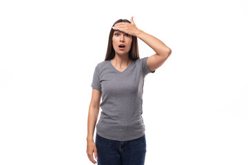 young slim brunette promoter woman dressed in a gray t-shirt with a mockup on a white background with copy space