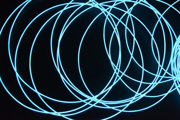A glowing chaos of thin light wires. An unusual, unique glowing background of chaotically stacked...