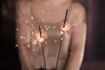 Captivating winter sparklers held by a mysterious woman, adding an enigmatic touch to the scene....