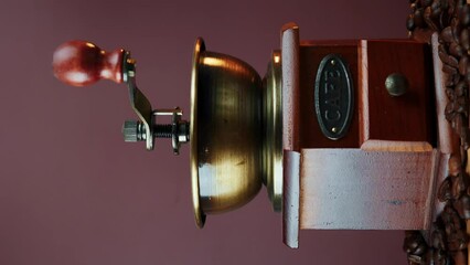 Coffee beans are falling into vintage manual coffee machine. Vertical video