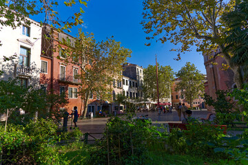 Old town of City of Venice with scenic view of town square with people relaxing on a blue cloudy summer day. Photo taken August 6th, 2023, Venice, Italy.