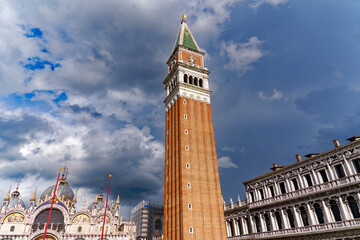 Looking up brick wall church tower of cathedral at Piazza san Marco at City of Venice on a sunny summer day. Photo taken August the 6th, 2023, Venice, Italy. - obrazy, fototapety, plakaty