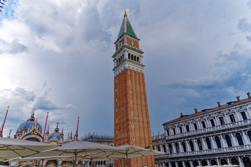 Fototapeta na wymiar Looking up brick wall church tower of cathedral at Piazza san Marco at City of Venice on a sunny summer day. Photo taken August the 6th, 2023, Venice, Italy.