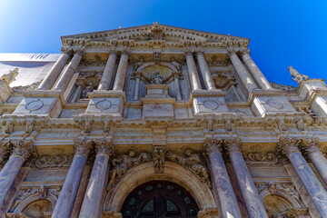 Looking up facade with entrance of cloister church Santa Maria di Nazareth City of Venice on a blue...
