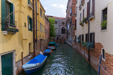 Fototapeta na wymiar Old town of Italian City of Venice with scenic view of canal with moored boats on a sunny summer day. Photo taken August 7th, 2023, Venice, Italy.